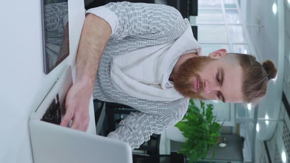 Vertical Screen Hipster Businessman Doing Company Analytics in Office