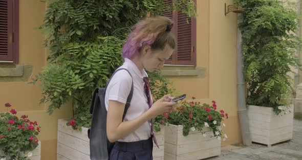 Beautiful Student Teenager Girl with Smartphone Reading and Writing Text Message