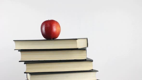 Books And Apple as Symbol of Knowledge Rotating