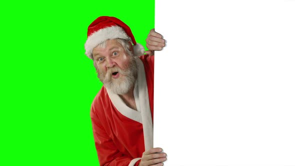 Surprised santa claus waving hand on green screen