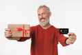 Smiling caucasian mature middle-aged man holding birthday Christmas present - PhotoDune Item for Sale