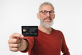 Closeup focused photo of middle-aged mature man holding credit card - PhotoDune Item for Sale