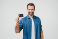 Smiling caucasian man bank client customer showing credit card  - PhotoDune Item for Sale