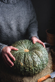 Hands Putting Ripe Green Pumpkin on Table - PhotoDune Item for Sale