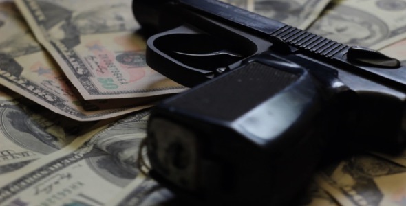 Dollars and Gun Rotating Close Up