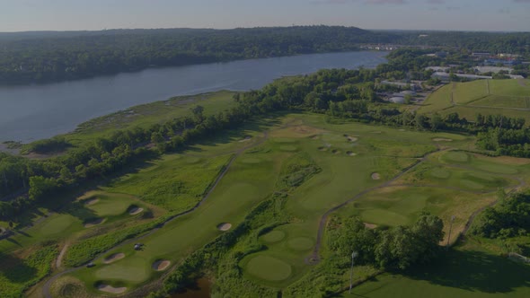 Aerial View of a Golf Course by the Water on a Sunny Day