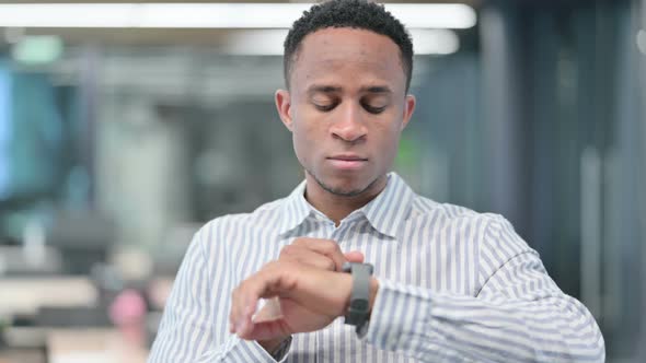 African Businessman Using Smart Watch