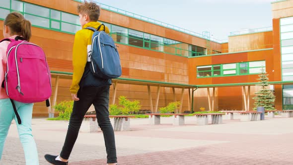 Children with Backpacks Going To School