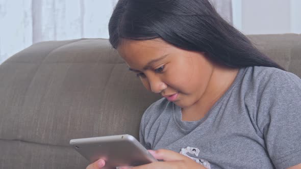 Asian Girl Playing With Tablet  alt