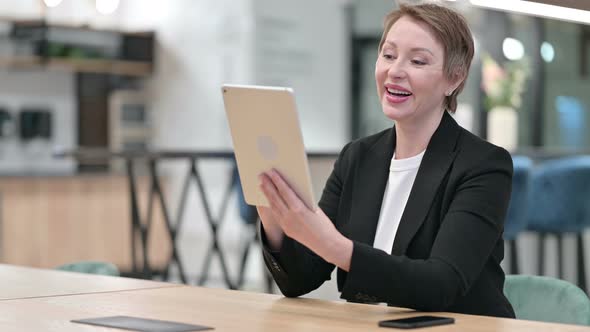 Old Businesswoman Doing Video Call on Tablet 