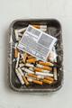 Top view plastic wrapped pile of used cigarettes. - PhotoDune Item for Sale