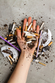 Hand holding pile of cigarettes with dirt. - PhotoDune Item for Sale
