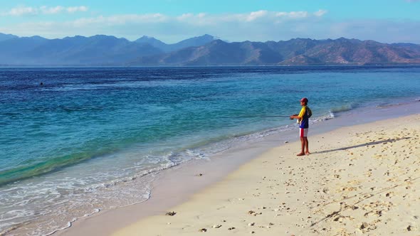 Angling for cool traveller on a trip hanging out on beach on paradise white sand and blue background