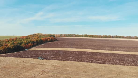 An Autumn Landscape - Tractor Plows the Field