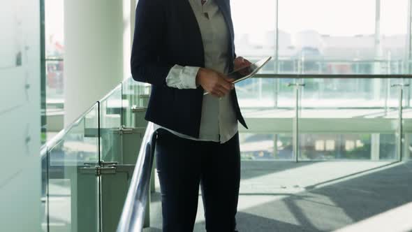 Businesswoman using tablet in modern office building