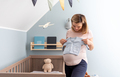 Pregnant woman preparing child clothes for expected newborn baby - PhotoDune Item for Sale