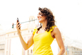 Woman looking at mobile phone screen in the city center - PhotoDune Item for Sale