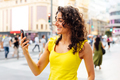 Happy business woman looking at mobile phone in the city - PhotoDune Item for Sale