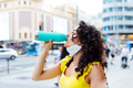Woman drinking from a bottle in the city center - PhotoDune Item for Sale