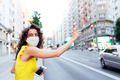 Portrait of a woman with face mask calling a taxi in the city - PhotoDune Item for Sale