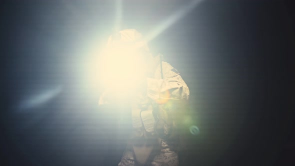 Soldier in Camouflage with a Gun is Moved in the Darkness