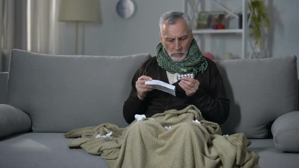 Sick Man Reading Instructions for Taking Flu Relief Tablets, Medical Advice