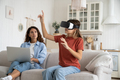 Interested teenage girl uses VR headset to visit metaverse or watch 3D movies from comfort home - PhotoDune Item for Sale