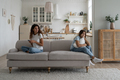 Lonely bored teenage girl sitting on sofa with working online mother, need attention from parent - PhotoDune Item for Sale
