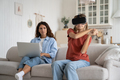 Teen girl child in virtual reality glasses playing games while her mother working remotely at home - PhotoDune Item for Sale