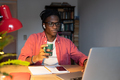 Young African millennial guy student using laptop for remote learning, studying online at home - PhotoDune Item for Sale