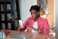 Frustrated young African self-employed man getting unexpected bad news while working from home - PhotoDune Item for Sale