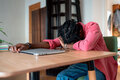 Exhausted overloaded African guy remote worker sleeping on desk, suffering from freelancer burnout - PhotoDune Item for Sale