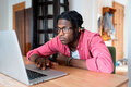 Sad African guy remote worker feeling uninspired unmotivated while doing boring freelance project - PhotoDune Item for Sale