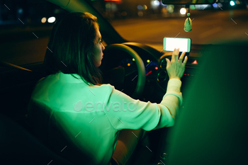 art phone while driving car at night.