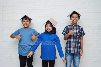 Smart school happy kids smiling and putting books on head