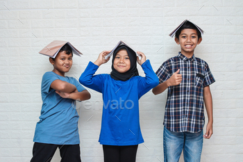 Smart school happy kids smiling and putting books on head