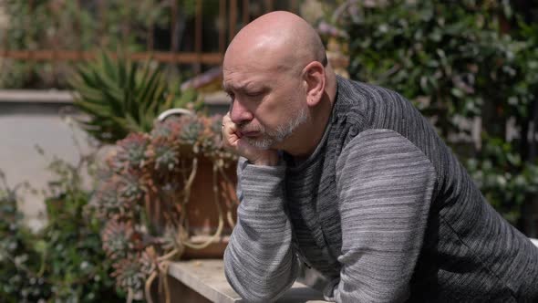 Lockdown - pensive man facing the balcony shaking his head