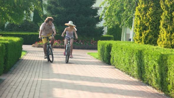 Young Man and Woman Cycling Outdoors