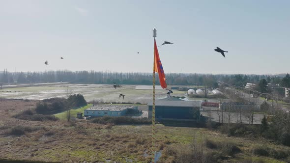 Aerial orbiting around Nishan Sahib triangular flag on Gurdwaras building