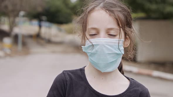 Coronavirus pandemic close up on girl face wearing face mask to avoid contagion