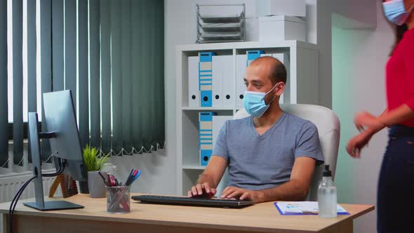 Coworkers with Face Masks Working