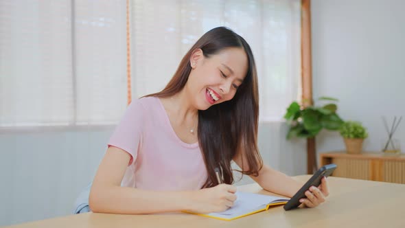 Asian attractive girl student winner feel happy after found out good news on phone then celebrate.