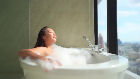 Young asian woman relax in bathtub