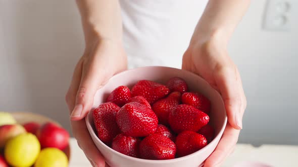 Woman's Hands with Bowl with Strawberries