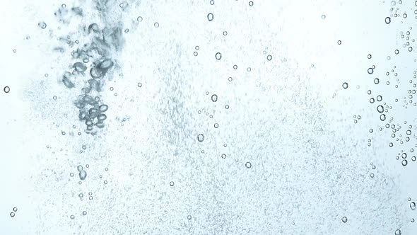 Close up pouring sparkling water in glass