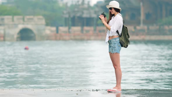 Happy Woman on Vacation Photographing with a Dslr Camera