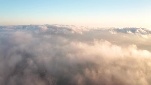Low clouds over a sea coastline at sunrise alt