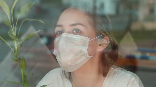 Young Student Teenager Girl in Protective Mask Standing Near Window on Home Self Isolation