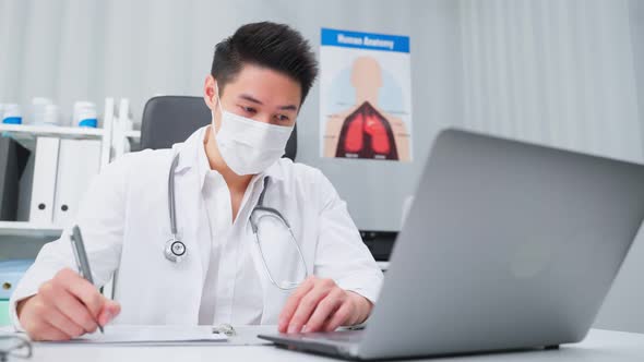 Asian professional medical doctor male working from office hospital.