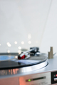 Close-up of vinyl record player, playing Christmas carols. Bokeh lights in the background. - PhotoDune Item for Sale